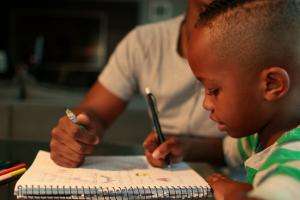 Boy drawing on pad