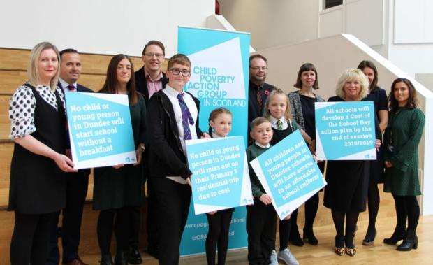 School children holding placards with pledges