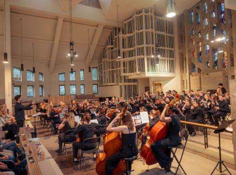 Musicians performing in an orchestra hall